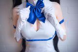 Erotic image nailed to the valley of her boobs shown by a naughty cosplayed layer